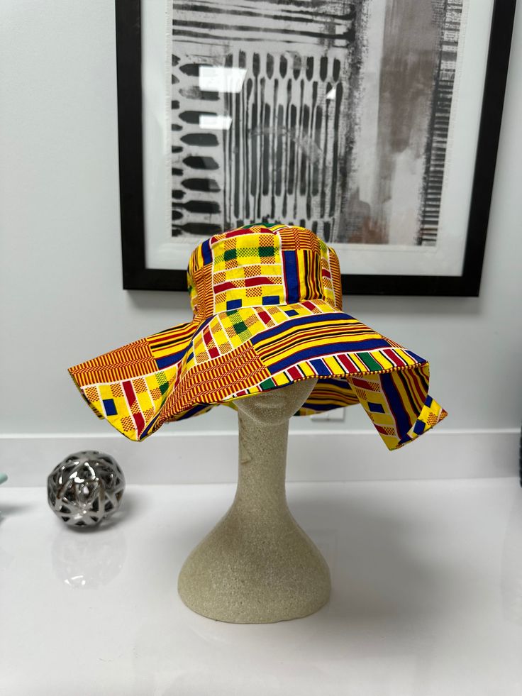 Enjoy our over sized African print sun hat this summer!! Hat with its wide range brim makes it very useful as a beach hat without compromising on fashion! Your Ankara hat is not too big or too small; Just the right statement piece! Not crazy about the beach? Wear it to your cookouts or fun garden party or outdoor festivals with your favorite solid colored outfits. *Hats will arrive folded and can be ironed to take any creases out or wear it just the way it falls with folds. *Lighting may alter c Multicolor Curved Brim Bucket Hat For Summer, Yellow Curved Brim Hat For The Beach, Multicolor Short Brim Hat With Uv Protection, Multicolor Sun Hat With Short Brim For Beach, Yellow Fedora Sun Hat For Summer, Multicolor Short Brim Sun Hat For Vacation, Multicolor Short Brim Sun Hat For Beach, Yellow Beach Hat With Short Brim, Multicolor Curved Brim Hat For Beach