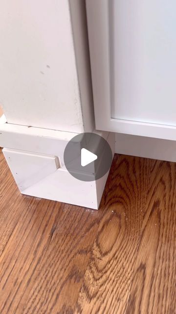 the corner of a kitchen cabinet door with a video showing how to open it and what is inside