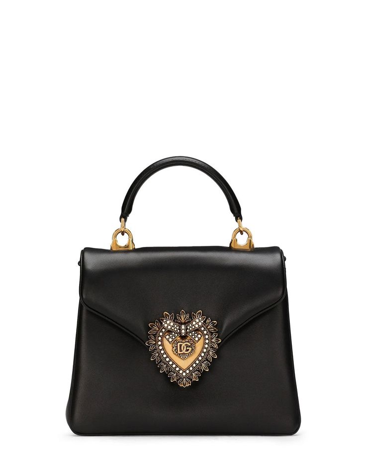 Dolce and Gabbana Devotion Tote Bag in Black Envelope flap top with magnetic closure Flat top handle Removable chain shoulder strap One interior slip pocket Signature embellished heart ornament Gold hardware Leather outer Fabric lining 5”W x 5.1”H x 1.8”D Made in Italy Dolce And Gabbana Bag, Black Shoulder Bag, Dolce & Gabbana, Handle Bag, Nappa Leather, Bago, Leather Tote Bag, Leather Top, Small Bags