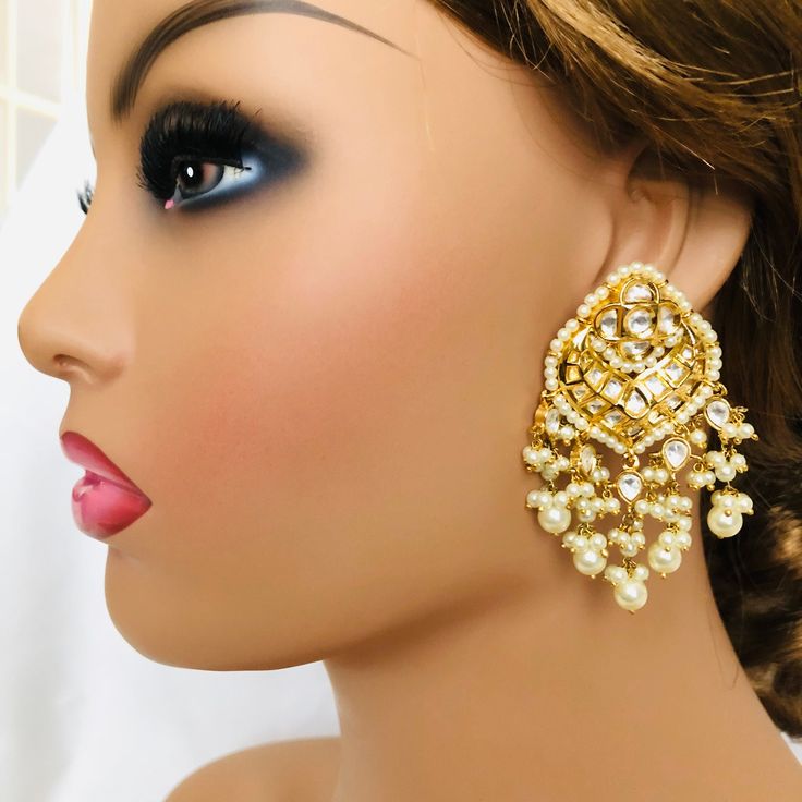 Tiyaani Kundan Pearl Chandbali/Kundan Earring/Sabyasachi Kundan Chandbali earring/Kundan Indian wedding Jewelry/Bridal earring @AryaFashions Traditional Chandbali Earrings Meenakari Handwork Handcrafted To Perfection Light Weight Earrings Perfect For Indian Weddings And Celebrations A Beautiful & Memorable Gift for Weddings or engagement. Length: 2.5 Inches Follow us on social media for new and latest designs: Facebook: www.facebook.com/shoparyafashions Pinterest: www.pinterest.com/aryafashions White Kundan Chandelier Earrings For Receptions, White Kundan Chandbali Chandelier Earrings, White Chandbali Bridal Earrings For Reception, Kundan Dangle Chandbalis For Reception, Kundan Meenakari Bridal Earrings For Reception, White Kundan Bridal Earrings For Diwali, White Kundan Bridal Earrings With Cutdana, Reception Kundan Dangle Chandbalis, Diwali White Kundan Bridal Earrings