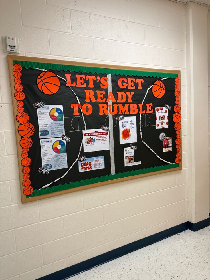 a bulletin board with basketballs on it in a school hallway that reads let's get ready to rumble