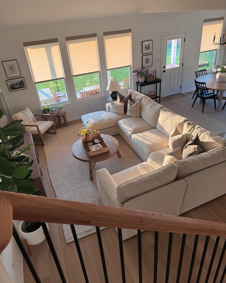 an aerial view of a living room with couches, tables and chairs in it