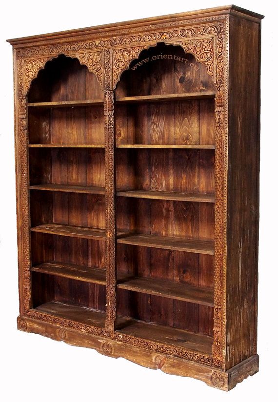 an old wooden bookcase with carvings on it