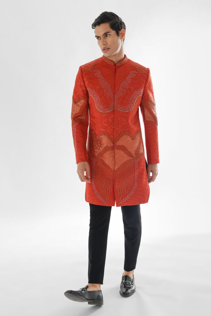 Rust sherwani style achkan featuring sequin and crystal embellished abstract patterns. Comes with pant.
Components: 2
Pattern: Embroidered
Type Of Work: Crystal,Thread
Neckline: Mandarin Collar 
Sleeve Type: Full
Fabric: Achkan: Modal Satin, Pant: Malai Cotton
Color: Orange
Other Details: 
Curved hem
Fitted silhouette
Occasion: Sangeet,Cocktail and Reception - Aza Fashions Fitted Hand Embellished Kurta For Eid, Designer Embellished Long Sleeve Sherwani, Festive Hand Embellished Kurta, Embellished Long Sleeve Bandhgala For Festivals, Bollywood Style Hand Embellished Kurta For Festivals, Fitted Hand Embellished Kurta For Wedding, Hand Embellished Long Sleeve Kurta For Reception, Bollywood Embellished Sherwani For Party, Party Sherwani Embellished For Eid