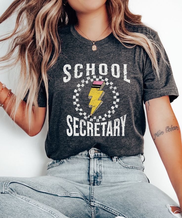 Embrace a vintage vibe with our Funny School Secretary Shirt, perfect for the new school year. This Back To School Tshirt is a Cute T-shirt Gift for School Secretary, blending classic style with modern comfort. Ideal for school receptionists, this Admin Squad Tee is a thoughtful way to show appreciation for their hard work and dedication. Product Description: ⇝ Bella and Canvas Brand Shirts ⇝ Unisex Adult Sizing ⇝ Rolled Sleeves in pictures are for styling purposes only ⇝ Props used in photos fo Retro Crew Neck T-shirt For School, Retro T-shirt With Letter Print For College, Retro College T-shirt With Screen Print, Retro Black T-shirt For School, College Style Short Sleeve T-shirt For School, School Spirit T-shirt With Text Print For School Events, School T-shirt With Graphic Print And Relaxed Fit, Graphic Tee With Graphic Print For School Events, Graphic Print Tee For School Events