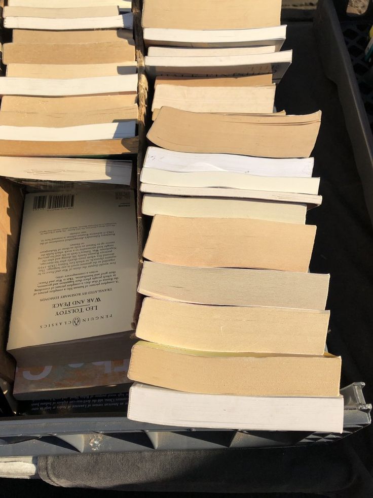 several stacks of books sitting on top of a table