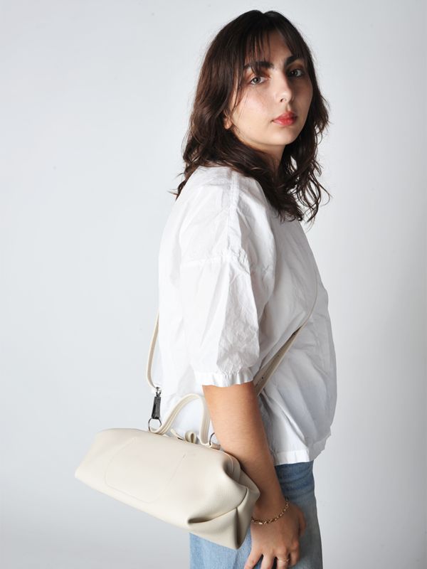 The baguette bag is a charming framed ladies bag. softly structured in a supple leather and lightweight it has a snap top closure and a detachable adjustable strap which allows for multiple carry options.    • handmade in utrecht the netherlands  • 14"l x 6"h x 5"d - unlined  • detachable adjustable shoulder strap 38" - smoke hardware  • 3.5" handles  • single snap top frame closure.  2 small drop down pockets on either side of the bag  • exclusive to roztayger in the us On-the-go Baguette Satchel Bag With Adjustable Strap, On-the-go Satchel Baguette Bag With Adjustable Strap, Timeless Baguette Bag With Detachable Handle For Daily Use, Everyday Baguette Satchel Bag With Adjustable Strap, Everyday Satchel With Detachable Top Handle, Chic Cream Box Bag For Everyday Use, Timeless Beige Satchel For Everyday Use, Beige Baguette Bag With Leather Top Handle, Beige Baguette Bag With Top Handle And Leather Handles