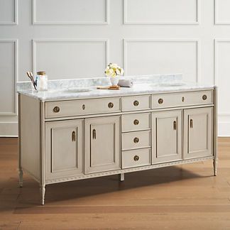 a kitchen island with marble top and drawers