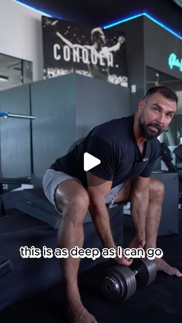 a man is squatting down while holding a dumbbell in his right hand, with the caption that reads, this bs deep as deep as i can go