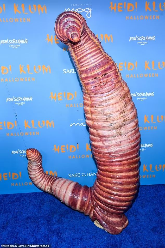 a very strange looking object on the blue carpet at an event in front of a backdrop