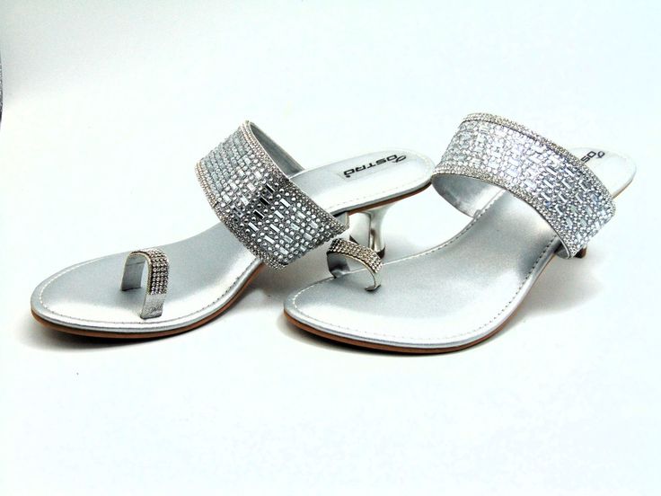 From our newest collection, A gorgeously crafted silver wedge with a toe ring strap set with silver colored crystals and a center strap intricately adorned with silver crystals and crystal rectangles. The padded base makes it comfortable to wear for extended periods of time. With 2 inches heels these are cozy enough to wear out on a date, to dinner, or for any other special event. For a larger selection of the shoes we sell, visit our page. We send packages to you promptly and well packaged for a safe journey. We appreciate your help with our small business. shipped from the USA. sizes offered: US 6, 7, 8, 9, and 10 Elegant Silver Sandals With Crystal, Silver Open Toe Sandals With Rhinestones, Silver Crystal Sandals, Sparkling Silver Sandals For Formal Occasions, Silver Crystal Open Toe Heels, Silver Heels With Single Toe Strap For Wedding, Silver Sparkling Crystal Heels, Crystal Silver Sparkling Heels, Silver Crystal Sparkling Heels