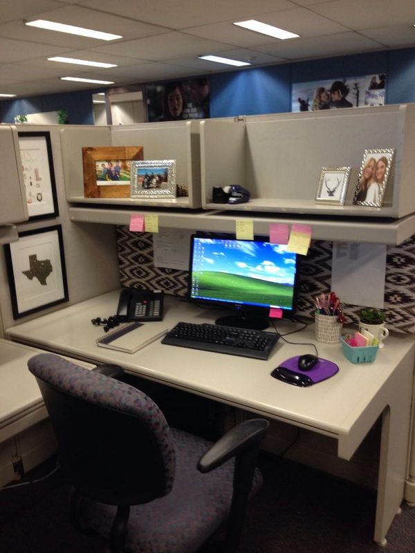 an office cubicle with a computer on the desk