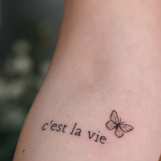 a small tattoo with the words cest la vie and a butterfly