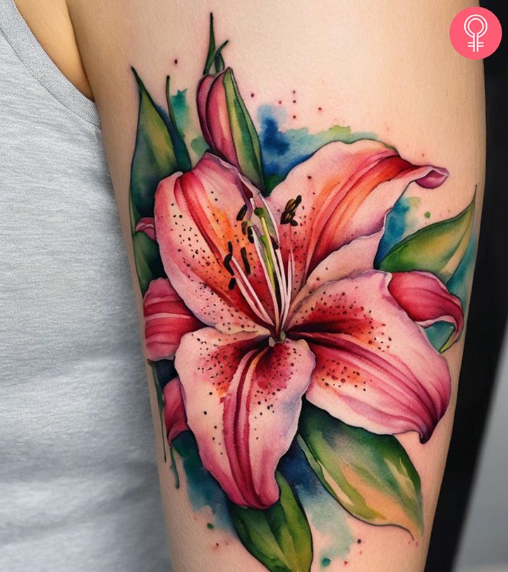 a woman with a tattoo on her arm has a pink flower and green leaves painted on it