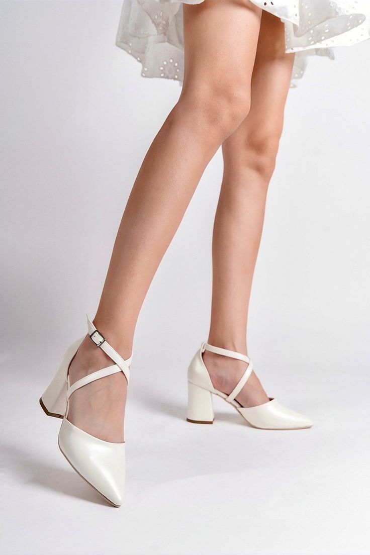 IVORY WEDDING SHOES, IVORY HIGH HEELS, BRIDAL SHOES, WEDDING HEELS, IVORY BLOCK HEELS, IVORY BRIDAL HEELS, CRISS CROSS HEELS As Eleanor Louise, we stand out with our Ivory heeled shoes that combine style and comfort. Specifically designed for brides, these shoes are crafted with high-quality materials. * Made from Premium Vegan Leather, our shoes are equipped with an ankle strap that provides comfort throughout the day. * Completing your style and boosting your confidence is the most elegant way Cream Block Heels With 4-inch Heel And Round Toe, Cream Closed Toe Block Heels For Party, Cream Block Heels With Wrapped Heel For Formal Occasions, Cream Pointed Toe Block Heels With Heel Strap, Cream Block Heels With Heel Strap And Pointed Toe, Cream Ankle Strap Heels With 4-inch Heel, Cream Heels With 4-inch Heel And Ankle Strap, Formal Cream Block Heels With Wrapped Heel, Cream Pointed Toe Block Heels For Party