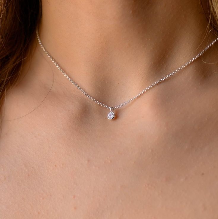 This dainty tiny Cubic Zirconia pendant necklace has a delicate chain and a minimalist style. It is so elegant and can be layered with other necklaces. The chain is solid sterling silver 925., and there is an extension so that the size can be adjusted. If you would like a custom order or have any questions please contact me, thanks. Delicate Sterling Silver Birthstone Necklace With Clavicle Chain, Delicate Sterling Silver Solitaire Necklace, Delicate Silver Diamond Necklace With Birthstone, Delicate Sterling Silver Birthstone Necklace, Dainty Diamond Clavicle Chain Necklace As Gift, Dainty Birthstone Necklace With Delicate Pendant Chain, Delicate Sterling Silver Birthstone Necklace With Delicate Chain, Dainty White Gold Solitaire Necklace With Clavicle Chain, Sterling Silver Minimalist Solitaire Choker