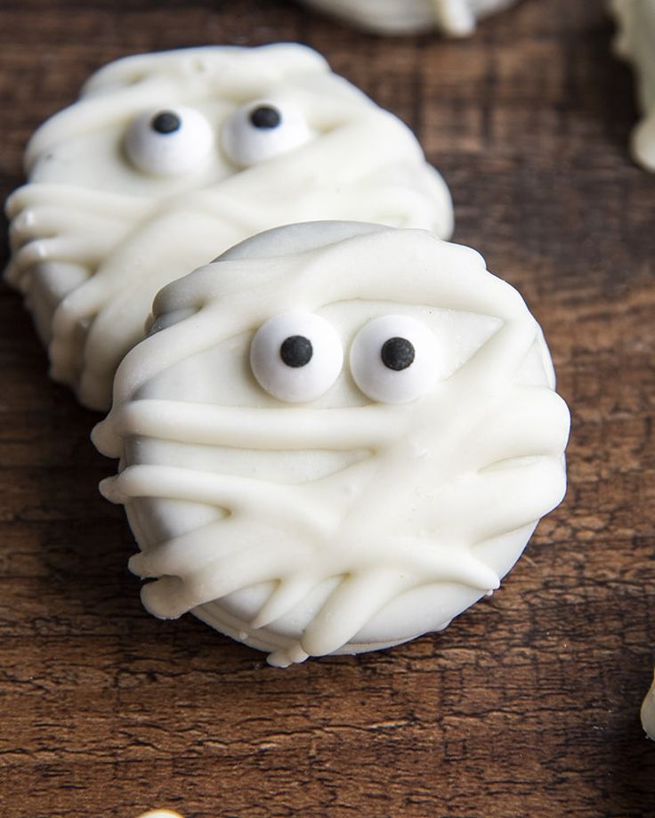 some white cookies with googly eyes on them