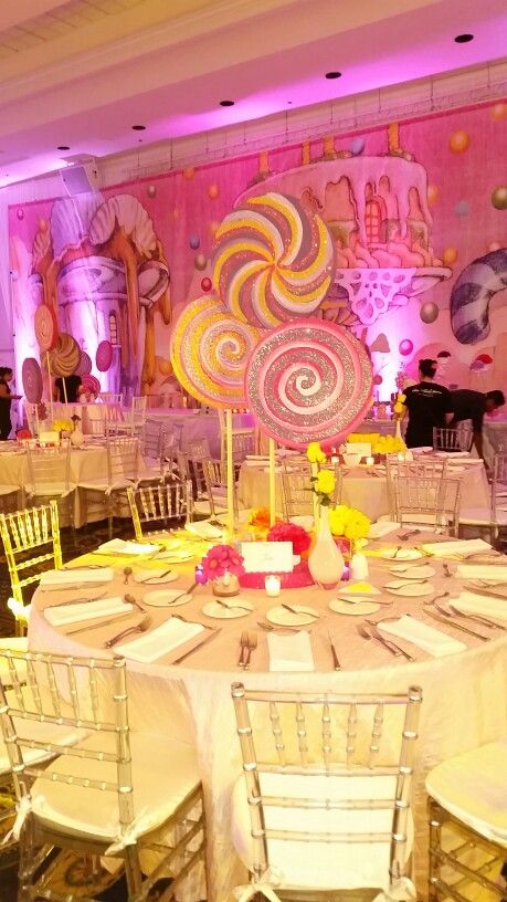 the tables are set up with white linens and yellow chairs for guests to sit at