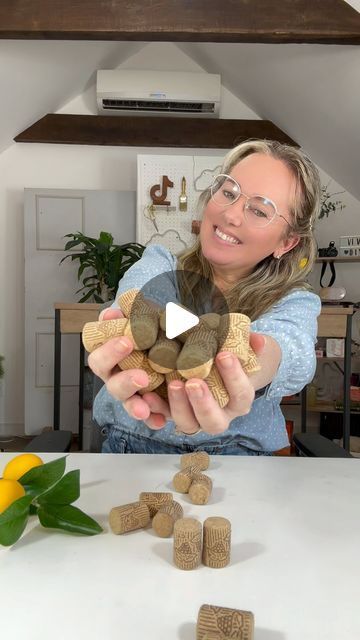 a woman sitting at a table with rocks in front of her and a video playing on the screen