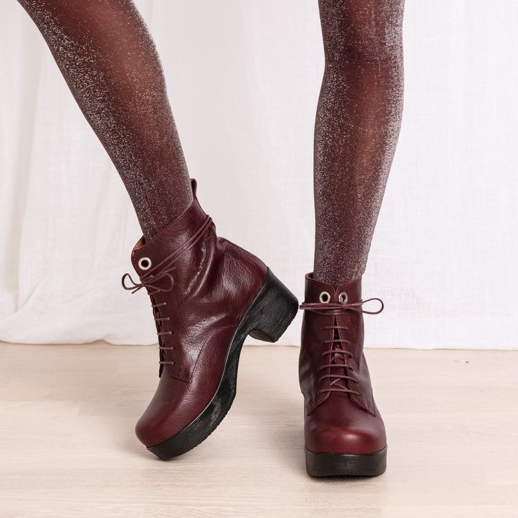 The Jonna lace-up boot in soft Plum leather makes a chic statement. The boot features a low, chunky clog-style heel in contrasting black and a pull-tab for easy wear. The removable anatomical sole provides optimal support, while our unique flexible sole means the Jonna boot can be worn comfortably all day long. Handmade in Portugal Unique Calou sole, soft and lightweight removable anatomic footbed Heel height 5,5 cm / 2,16 in Shaft height 14 cm / 5,52 in Winter Lace-up Platform Boots With Leather Sole, Winter Leather Lace-up Boots With Low Heel, Winter Leather Lace-up Boots With Stacked Heel, Fall Lace-up Boots With Vibram Sole, High Ankle Lace-up Boots With Vibram Sole For Fall, Fall Lace-up Boots With Lug Sole And Medium Width, Fall Lace-up Boots With Lug Sole, Fall Wedge Ankle Boots With Leather Sole, Platform Lace-up Workwear Boots