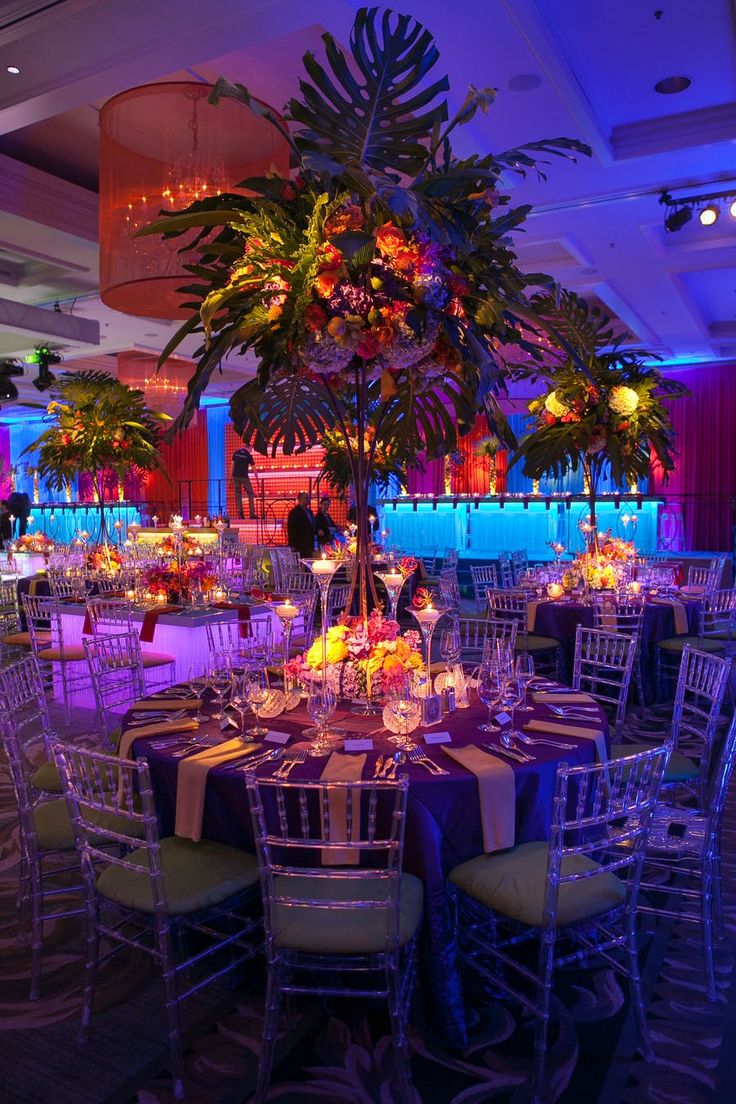 an indoor event venue with tables and chairs set up for a formal function at night