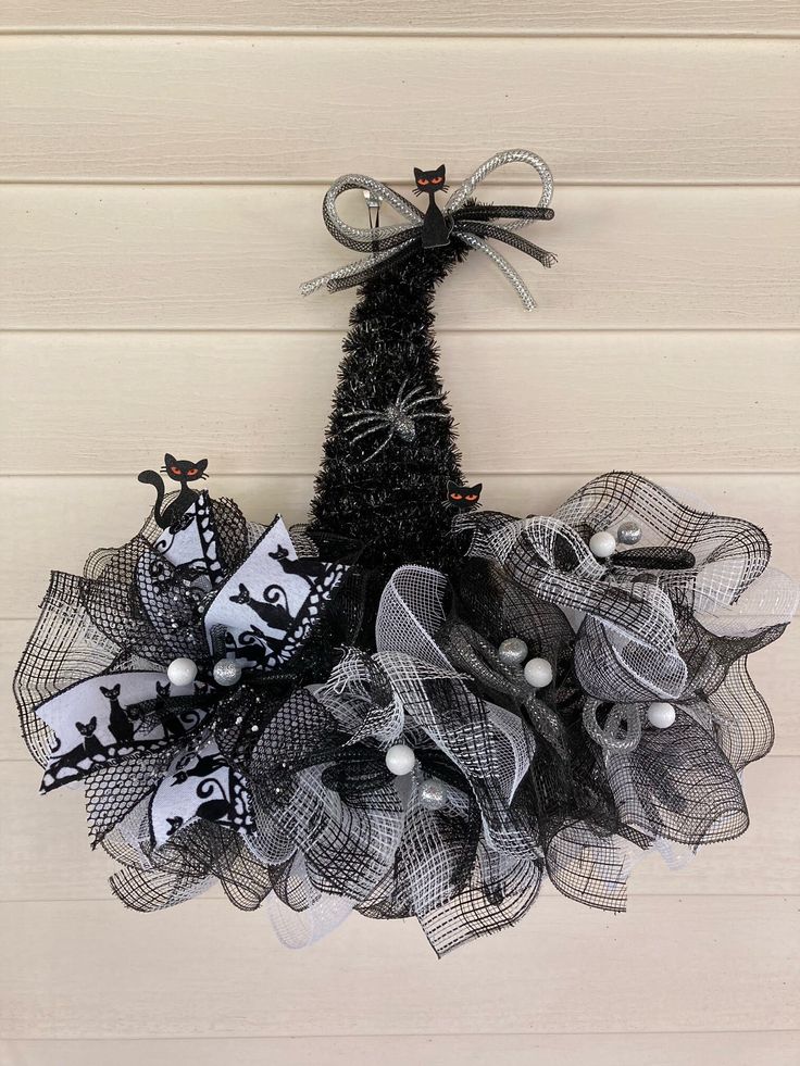 a black and white halloween wreath hanging on a wall