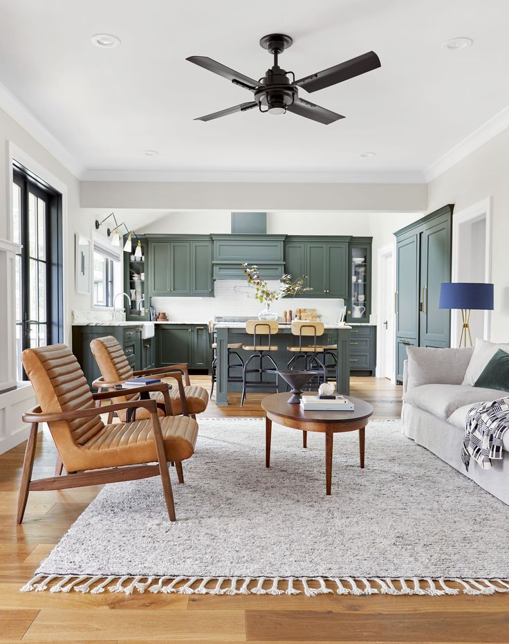 a living room filled with furniture and a ceiling fan