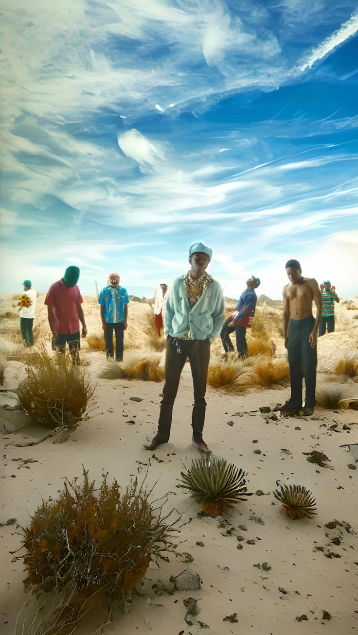 a man standing in the middle of a desert surrounded by other men and cactus plants