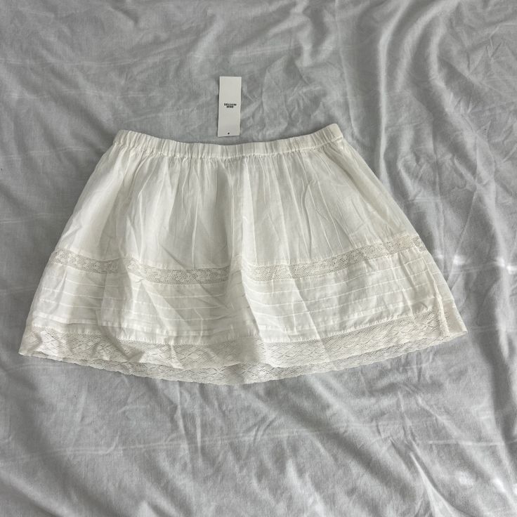 Urban Outfitters Mini White Skirt Size Small Condition: Nwt Color: White Details : - Lace Detailing - Pull Up Style - Can Be Styled Various Ways Extra: - I Ship Between 1-2 Days Vacation Cotton Skirt With Lace Trim, Summer Tiered Skirt From Urban Outfitters, Summer Tiered Skirt By Urban Outfitters, Urban Outfitters Casual Tiered Skirt, Urban Outfitters Skirted Summer Bottoms, White Summer Bottoms Urban Outfitters, Urban Outfitters White Summer Bottoms, Urban Outfitters Lined Mini Skirt For Day Out, Urban Outfitters Lined Tiered Skirt