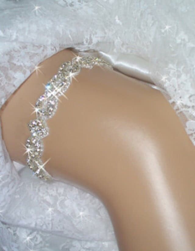 Garter, Weddings, Wedding Garter, Bridal Garter, Bridal, Rhinestone Garter, Crystal Garter, Garder, Wedding Garder,  Bling Garter Rhinestone trim bridal keepsake garter is encrusted with clear Czech crystals. in a unique and regal pattern. Rhinestone crystal and beaded trim is .75" wide and is a unique pattern of rhinestone twists and diamond shape. The crystals are accented with silver beads and the sparkling effect is breathtaking, especially when the light hits it The back is secured with a couple of inches of satin and cotton stretch elastic, so it should fit comfortably while staying in place on your special day. Please send me your thigh size approximately 6 inches above the knee. These are made to order The one pictured fits size 18 to 21 inches. This garter is also available as a s Sparkling Diamond White Wedding Dress, Silver Fitted Bridal Accessories, Elegant Bedazzled Bridal Belt For Wedding, Silver Bedazzled Bridal Belt For Wedding, White Bridal Sets, Adjustable Rhinestone Bridal Accessories, Fitted Rhinestone Bridal Accessories For Party, Silver Crystal Bridal Belt For Wedding, Bedazzled Crystal Bridal Belt For Wedding