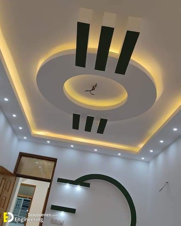 the ceiling is decorated with black and white accents, along with an illuminated clock on the wall