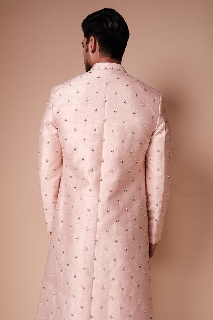 Light pink raw silk sherwani with pearl, sequin embroidery and mandarin collar. Paired with cotton silk blend kurta and gathered churidar.
Component: 3
Pattern: Embroidered
Type Of Work: Pearl and Sequin Work
Neckline: Mandarin Collar
Sleeve Type: Full Sleeves
Fabric: Sherwani: Raw Silk, Kurta and Churidar: Cotton Blend Silk
Color: Pink
Other Details: 
Front concealed closure
Front and side slits
Occasion: Groom,Destination Wedding - Aza Fashions Pink Sherwani, Raw Silk Kurta, Silk Kurta, Sequin Embroidery, Luxury Sale, Man Set, Sequins Embroidery, Churidar, Full Sleeves