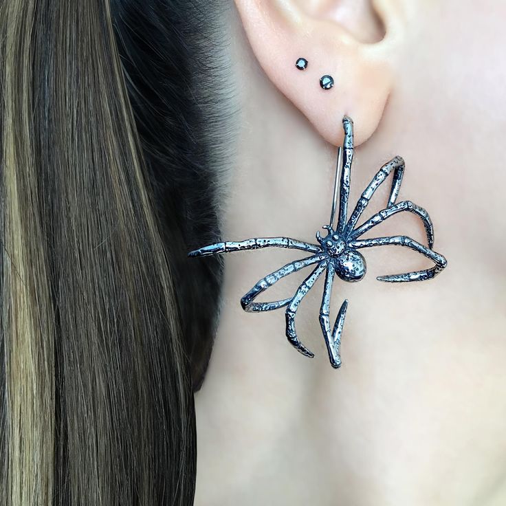 Add a touch of spookiness to your style with these Hanging Spider earrings . These unique and large spider earrings are perfect for Goths and Halloween enthusiasts. Get ready to make a statement with these eerie accessories. Sold as Pair Material 316 Stainless steel Total length :41 mm Total width: 47 mm Listing for  pair of earrings only *RETURNS / REFUNDS * -If you would like to return you purchase , please contact us within 7 days of receiving your package and we will accept the return.Return will only be made to the product, and not the shipping cost.  -Buyer is  responsible for the return shipping costs . -All jewelry must be returned unworn and in their original condition . *LOST MAIL* Once the package is marked as DELIVERED by the post office, we are not responsible for misplaced or Unique Halloween Party Jewelry, Edgy Halloween Jewelry, Handmade Punk Earrings For Party, Handmade Punk Style Earrings For Parties, Punk Style Handmade Earrings For Party, Gothic Plug Earrings For Halloween Gift, Edgy Pierced Halloween Earrings, Gothic Pierced Jewelry For Party, Edgy Pierced Earrings For Halloween