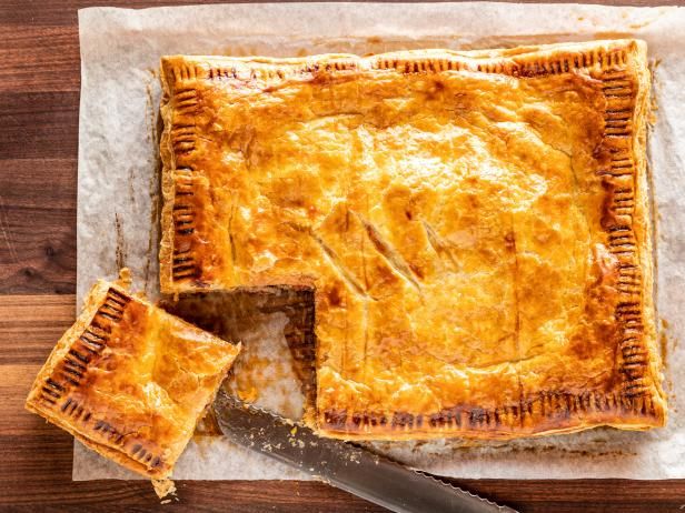 a piece of pie sitting on top of a cutting board next to a knife