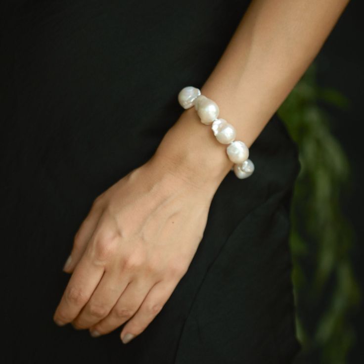 This large baroque pearl bracelet is made of white high luster baroque pearl beads. While making this statement bracelet, I used gold-plated balls on brass at the both ends of the bracelet. The combination of pearls and gold gives this handmade bracelet a classic and timeless look. The closure is 14k gold-plated spring ring.  The clasp and beads at both ends can be chosen in 925 sterling silver. This large pearl bracelet is perfect for formal events, cocktail parties, or a night out. This white natural pearl bracelet serves as the ideal complement to an evening dress, enhancing your overall look with its captivating charm.  ❤️ Designed especially for brides, this wedding bracelet is composed of exquisite freshwater pearls. ❤️ This elegant bridesmaid bracelet is meticulously crafted to perf Wedding Baroque Pearl Chain Bracelet, Baroque Pearl Bracelets For Wedding, Baroque Pearl Wedding Bracelets, Silver Baroque Pearl Bracelets For Weddings, Wedding Bracelets In Pearl White Baroque Pearl, Pearl White Baroque Pearl Bracelets For Wedding, Wedding Baroque Pearl Beaded Bracelets With Pearl Drop, Wedding Baroque Pearl Bracelets In Pearl White, Wedding Baroque Pearl Beaded Bracelet With Pearl Drop