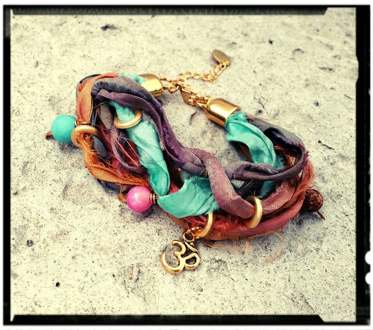 "Bohemian Wrap Bracelet in a Colorful Sari Silk Mix. Gold Rings, Natural Stone Beads and a Golden Om Charm. Lobster Clasp with 2\" Extension Chain allows for a perfect fit for any wrist size. You may leave your wrist measurement if you prefer. *Custom Orders Welcome* Gift Box, Extras, etc... May be purchased in the Ala Carte Listing. https://www.etsy.com/listing/286913011/ala-carte-ordersadd-onsextras-stainless" Handmade Bohemian Bracelets For Festival, Green Bohemian Wrap Bracelet For Festival, Silk Ribbon Jewelry, Sari Silk Jewelry, Silk Wrap Bracelets, Beaded Boho Necklace, Bohemian Wrap, Jewelry Making Classes, Om Charm