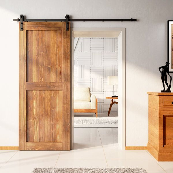 a living room with an open sliding door next to a white rug and wooden furniture