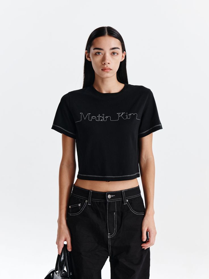 This is a casual and trendy t-shirt by Matin Kim that is made out of high quality and sturdy material. With distinctive mood of the design and comfortable wear, you can style it for your casual daily outfit.- MATIN KIM logo stitch detail- Cropped length and natural fit- Woven label point on the back Modern Black Crew Neck T-shirt, Modern Short Sleeve Top With Logo Print, Modern Fitted T-shirt With Graphic Print, Fitted T-shirt For Streetwear, Tan T-shirt For Spring Streetwear, Black Trendy T-shirt With Logo Print, Trendy Black T-shirt With Logo Print, Trendy Black Cotton T-shirt, Trendy Black Tops With Graphic Design