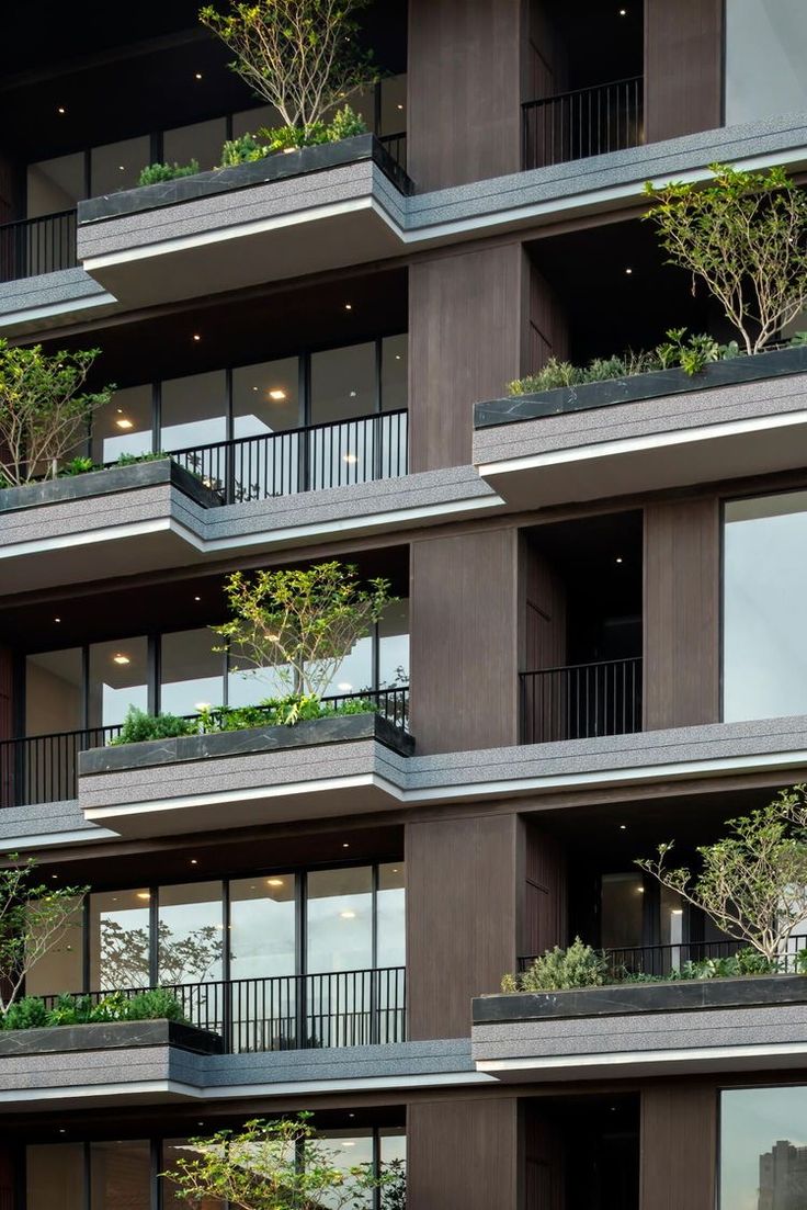 an apartment building with balconies and plants on the balconies