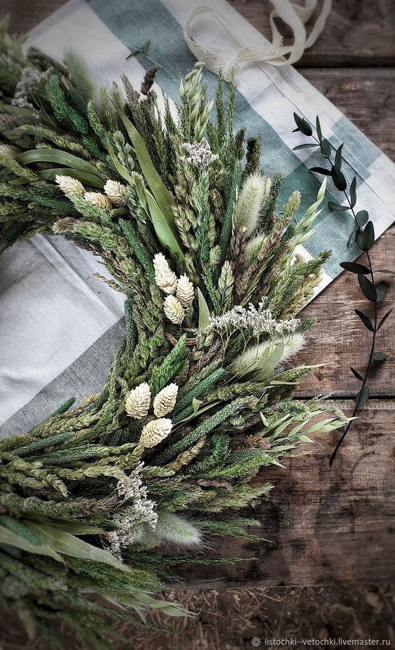 an arrangement of green and white flowers on a table