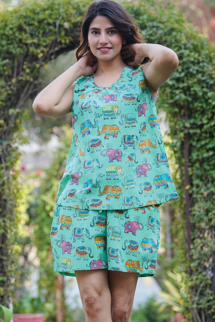 This pajama short set features a relaxed fit sleeveless tank with a round neckline and comfy drawstring elastic waist shorts with convenient pockets. Featuring a cute and colorful elephant print on a vibrant jade green background, this Pajama Short Set is made of 100% high quality woven Indian cotton and is perfect for all seasons, especially those Spring and Summer nights! This printed pajama set from Sevya Handmade is fair trade and machine washable. Available in combined sizes, S/M and L/XL. Comfortable Green Pajama Party Sets, Comfortable Green Sets For Pajama Party, Playful Loungewear Short Set, Green Summer Sleepwear For Pajama Party, Green Sleepwear For Summer Pajama Party, Green Cotton Summer Sets, Green Relaxed Fit Sleepwear For Summer, Casual Sleeveless Sets For Beach, Relaxed Fit Cotton Sleeveless Set