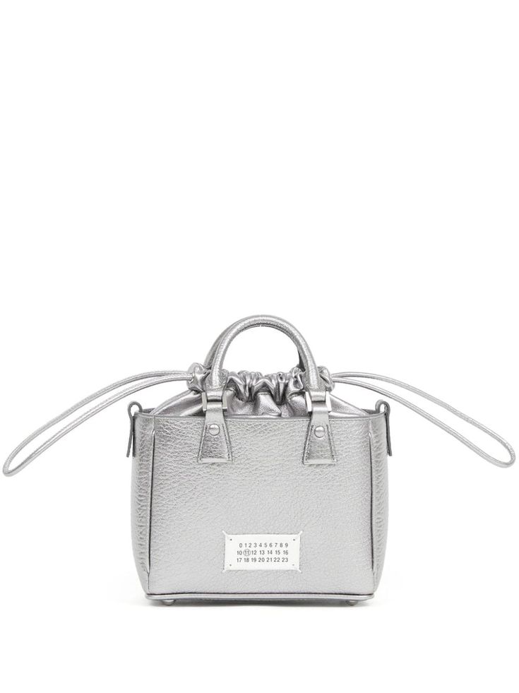 silver-tone calf leather metallic effect signature numbers motif two rolled top handles detachable leather and chain-link shoulder strap top drawstring fastening main compartment internal zip-fastening pocket Modern Silver Bag With Detachable Strap, Modern Silver Shoulder Bag With Top Carry Handle, Silver Shoulder Bag With Top Carry Handle, Modern Silver Bag With Top Carry Handle, Modern Silver Bags With Detachable Strap, Modern Silver Shoulder Bag With Top Handle, Metallic Leather Bag With Dust Bag Included, Silver Top Handle Shoulder Bag With Removable Pouch, Silver Leather Top Handle Shoulder Bag