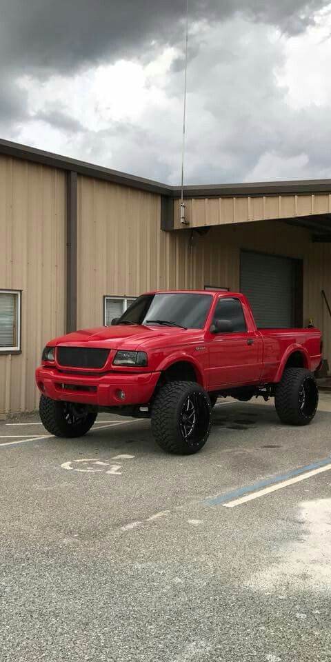 a red truck parked in front of a building