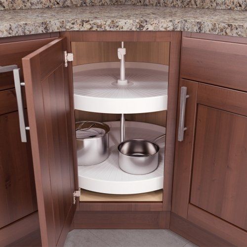 an open cabinet with pots and pans in it