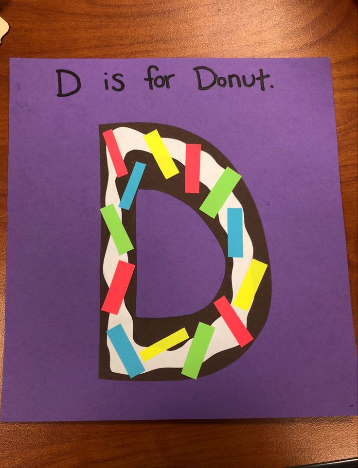 the letter d is for donut made out of colored crayons on purple paper