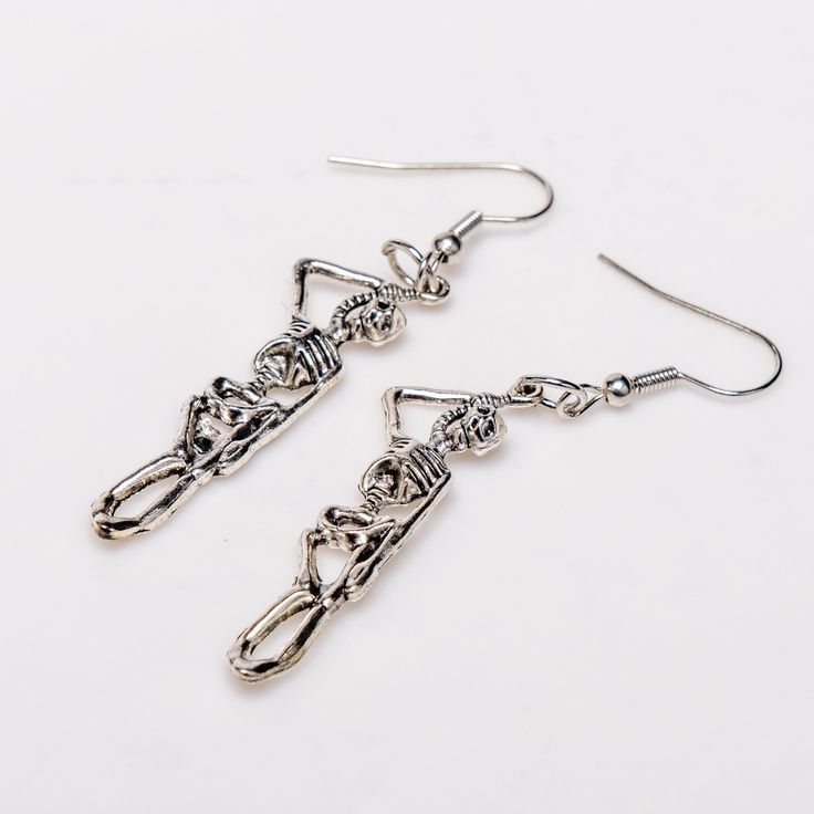 Elevate your gothic style with our Hang in There Earrings! Crafted from high-quality, hypoallergenic alloy, these 2.5-inch long earrings are designed to make a bold statement. Perfect for showcasing your unique taste, these earrings offer both style and comfort. Embrace your individuality and stand out with this stunning pair Trendy Metal Dangle Plug Earrings, Edgy Pierced Metal Earrings, Edgy Silver Drop Earrings, Nickel Free Punk Style Earrings, Edgy Drop Earrings With Ear Wire, Edgy Metal Earrings With Ear Wire, Trendy Halloween Dangle Earrings, Trendy Dangle Earrings For Halloween, Trendy Silver Halloween Earrings