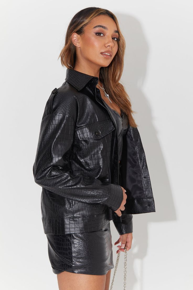 Elevate your outerwear game with our Oversized Faux Croc Trucker Jacket Co-ord. This standout piece combines edgy fashion with cozy comfort, making it a must-have addition to your wardrobe. The jacket boasts a unique faux crocodile texture, adding a touch of luxury and intrigue to your look. Its oversized fit provides an effortlessly cool vibe while ensuring you stay warm during cooler seasons. This co-ord set offers versatility by including matching pieces that complete your outfit. Whether you Fall Biker Jacket With Faux Front Pockets, Winter Shacket For Streetwear, Trendy Collared Outerwear For Night Out, Long Sleeve Outerwear With Button Closure For Night Out, Black Outerwear With Faux Front Pockets For Night Out, Black Shacket For Fall Streetwear, Black Shacket For Streetwear In Fall, Edgy Long Sleeve Outerwear With Pockets, Trendy Collared Winter Biker Jacket