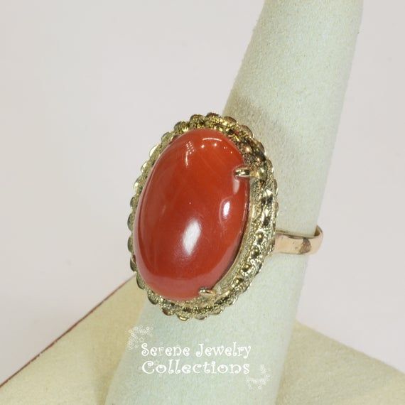 Vivid oxblood red Sardinia Coral Ring set in 14k yellow gold!Ring Size: 6.25Total Weight: 8.45 gramsPrecious Metal: 14k solid goldPrecious stones:-Coral Center Stone: 22.1mm x 15.5mm, 14.5caratsHallmark: 14k, TAIWAN Formal Carnelian Oval Cabochon Jewelry, Classic Yellow Gold Carnelian Jewelry, Formal Oval Cabochon Carnelian Jewelry, Classic Carnelian Yellow Gold Jewelry, 14k Gold Cabochon Jewelry For Anniversary, Formal Gold Carnelian Ring, Formal Carnelian Gold Ring, Formal Carnelian Cabochon Jewelry, Anniversary 14k Gold Cabochon Jewelry