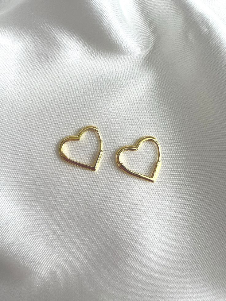 Introducing our enchanting Heart Hoop Sterling Silver Earrings - the perfect blend of elegance and romance for your jewelry collection. Silver Heart Hoops: Material: Solid Sterling Silver  Gold Heart Hoops: Material: Solid Sterling Silver  Finish: 18k Gold  Key Features  ✨ Size: Each hoop boasts a dainty .69-inch diameter, providing just the right size to contribute to your outfit without being overwhelming. ✨ Material: Crafted from solid sterling silver, these earrings are not only stunning but also durable for everyday wear. ✨ Hypoallergenic: Perfect for sensitive ears, our heart-shaped hoops are hypoallergenic, ensuring comfort and style for all. ✨ Comfortable and Lightweight: Experience the joy of all-day wear with these earrings - they are not only chic but also remarkably comfortable Tarnish Resistant Heart Hoop Earrings For Anniversary, Gold Open Heart Huggie Earrings For Everyday, Gold Sterling Silver Huggie Earrings For Valentine's Day, Elegant Huggie Earrings For Valentine's Day, Elegant Heart Huggie Earrings For Everyday Wear, Elegant Heart-shaped Huggie Earrings, Elegant Everyday Huggie Earrings For Valentine's Day, Elegant Valentine's Day Huggie Earrings, Dainty Tarnish Resistant Hoop Earrings For Valentine's Day