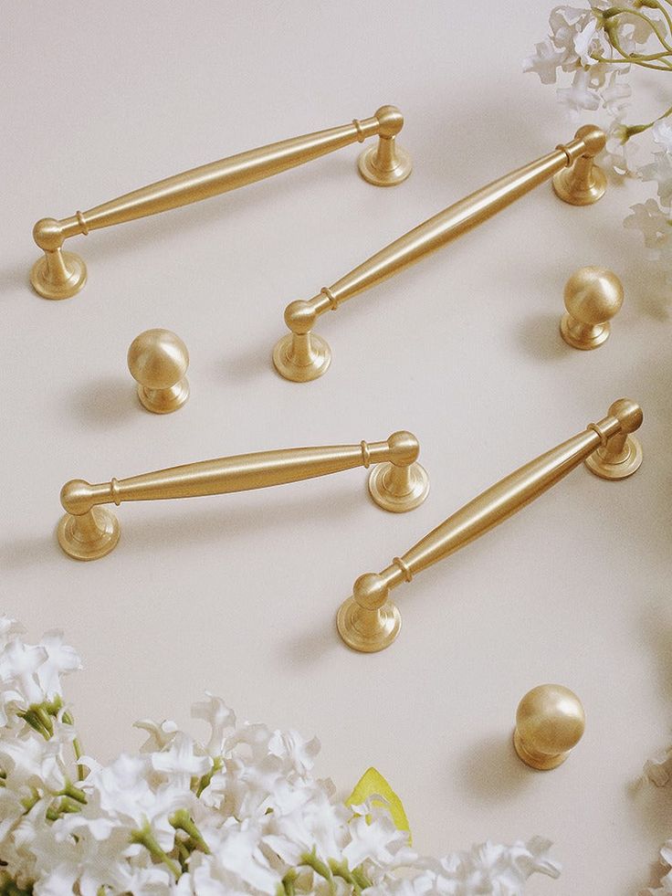 gold handles and knobs on white flowers